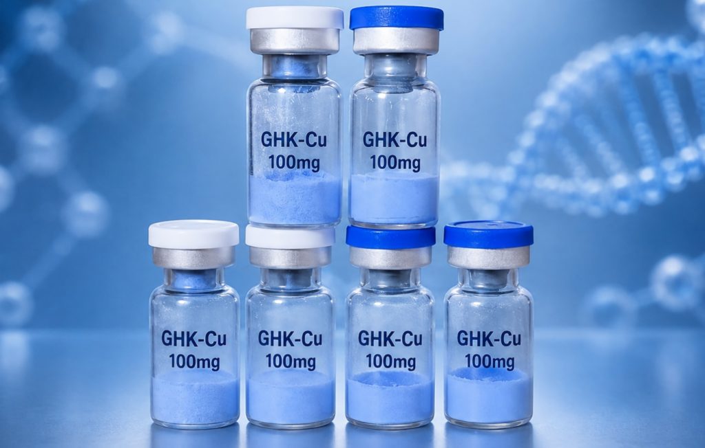 Six GHK-Cu 100 mg copper peptide vials on a blue laboratory background
