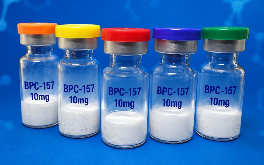 Five BPC-157 10mg peptide vials on a blue laboratory background
