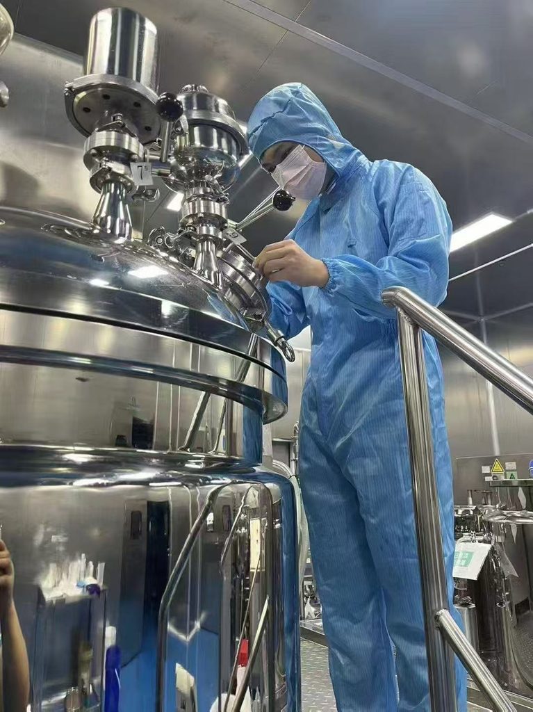 Sunone technician operating peptide manufacturing equipment in a controlled production facility